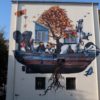 Un murales su ambiente e migranti